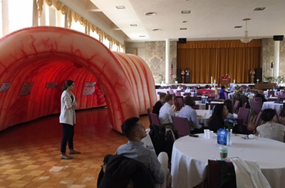 COE member standing inside a giant inflatable colon